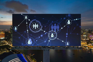 Glowing Social media icons on billboard over night panoramic city view of Singapore. The concept of networking and establishing new connections between people and businesses in Southeast Asia