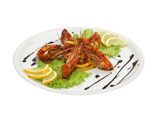 Spicy shrimps with lemon and lettuce on white round plate isolated