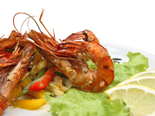Spicy shrimps with lemon and lettuce on white background