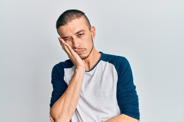 Hispanic young man wearing casual clothes thinking looking tired and bored with depression problems...