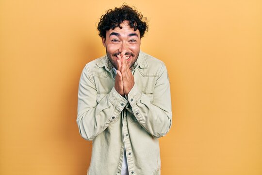 Young hispanic man wearing casual clothes praying with hands together asking for forgiveness smiling confident.