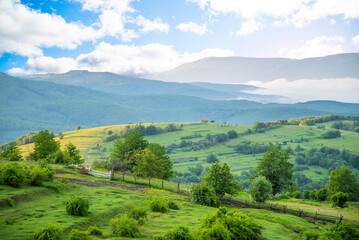 morning mountains in the fog at sunrise in the countryside. Nature landscape.