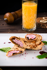 Crepes filled with cottage cheese and orange juice for breakfast