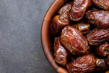 Top view of Dried date palm in bowl on black background