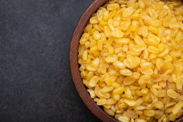 Deep frying  peeled split mung beans in a bowl