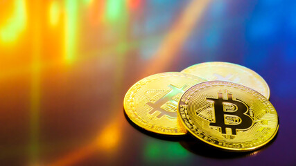 Bitcoin currency with blockchain concept : Golden coin placed on screen with candle charts and graphs. Crypto investment security and strategy.