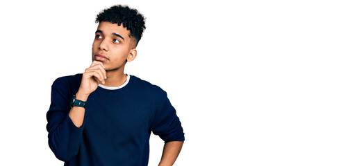 Young african american man wearing casual clothes with hand on chin thinking about question, pensive expression. smiling with thoughtful face. doubt concept.