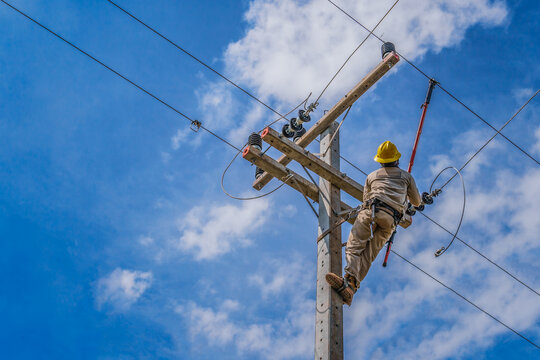 The power lineman use clamp stick (insulated tool) to closing a transformer on energized high-voltage electric power lines. The power lineman must be trained because it is a risky job