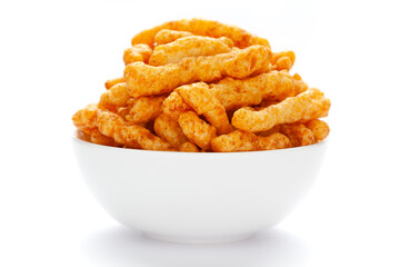 Close up of tangy Potato Puff Snacks sticks, Popular Ready to eat crunchy and puffed snacks sticks tangy spicy  orange color over white background - obrazy, fototapety, plakaty
