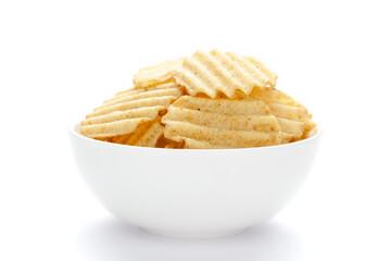 Close up of Wrinkled Wavy Potato Chips in white ceramic bowl, Popular Ready to eat crunchy, salty pale-yellow color over white background