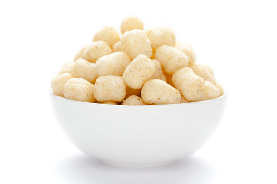 Close up of Cheese Potato Puff Snacks ball and buds, Popular Ready to eat crunchy and puffed snacks buds, cheesy salty pale-yellow color over white background