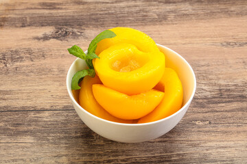 Sweet ripe canned peaches with mint