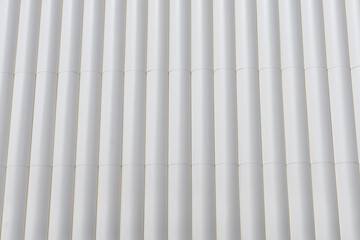 circular metal structure made of several white tubes as a cladding for an outer wall of an external...