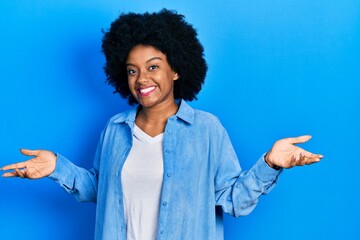 Young african american woman wearing casual clothes smiling showing both hands open palms, presenting and advertising comparison and balance