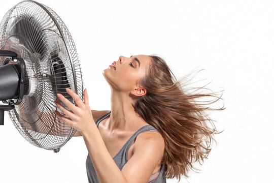 Young Woman Cooling Down With Electric Fan