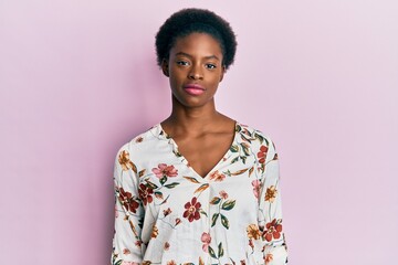 Young african american girl wearing casual clothes relaxed with serious expression on face. simple and natural looking at the camera.