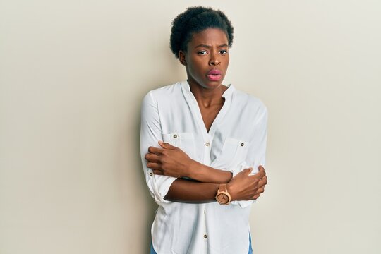 Young african american girl wearing casual clothes shaking and freezing for winter cold with sad and shock expression on face