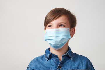 Portrait of child boy in face mask on white background
