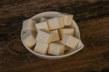 Refined white sugar cubs in the bowl