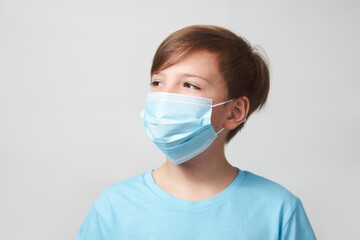 School boy with face mask on white background