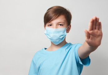 School boy with face mask on white background