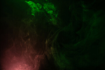 Fototapeta na wymiar Green and pink steam on a black background.