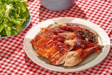 Summer party menu with beef, shrimp, roasted duck, fresh vegetable and sea grapes on red white caro background