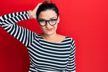 Young caucasian woman wearing casual clothes and glasses confuse and wonder about question....