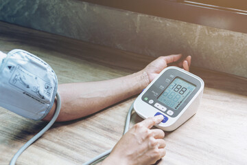 Woman is taking care for health with hearth beat monitor and blood pressure. Health care.