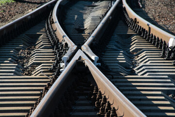 Converging railroad tracks close up on a sunny summer day. Travel, life and business planning...