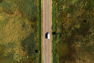 Aerial view of lorry truck on the road through countryside