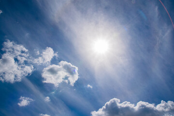 Beautiful sky with sun and clouds, copy space, beautiful blue background with place for text