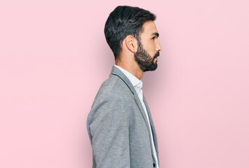 Young hispanic man wearing business clothes looking to side, relax profile pose with natural face and confident smile.