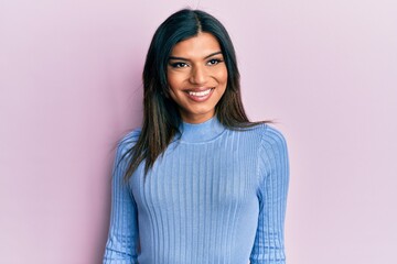 Young latin transsexual transgender woman wearing casual clothes looking away to side with smile on face, natural expression. laughing confident.