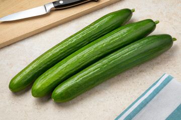Whole fresh green cucumbers ready to cut and cook 