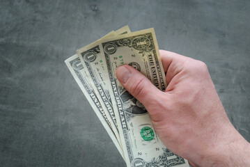 Three banknotes of one American dollar in hand