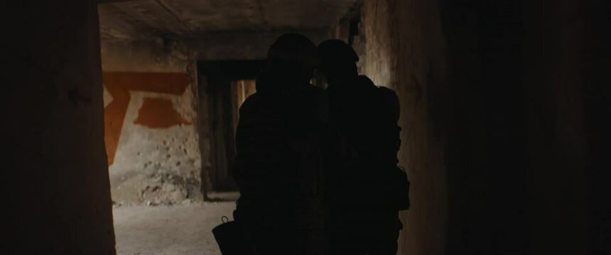 HANDHELD TRACKING Soldiers taking part in military operation inside building. Shot with 2x anamorphic lens