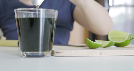 Mixing green tea with lime and honey.