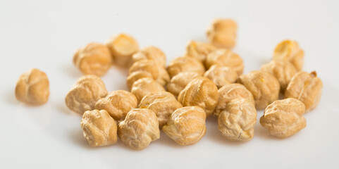 Chickpea seeds closeup on white surface. Organic food for healthy eating..