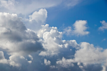 Bright blue sky with white fluffy cloud.