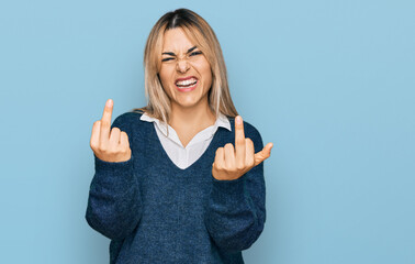 Young caucasian woman wearing casual clothes showing middle finger doing fuck you bad expression, provocation and rude attitude. screaming excited