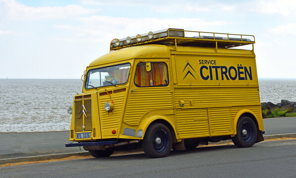 Classic yellow  Citroen Hy Van with Service Citroen logo on the side parked on seafront promenade.