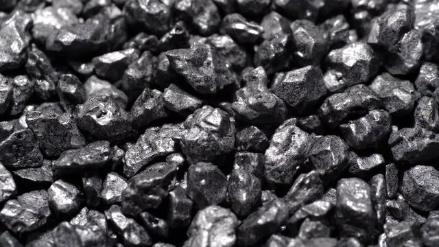 Stone ore close-up. Black stones grunge background.