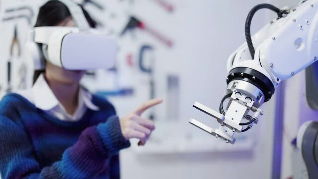 Concept of virtual reality, simulation, Robot arm and future technology.Asian Engineers Maintenance Robot Arm at Lab. they are in a High Tech Research Laboratory with Modern Equipment. 
