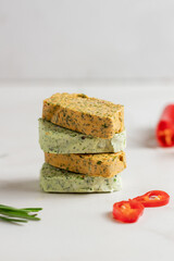 Homemade butter with herbs, rosemary, garlic, onions and butter with papper lying on top of each other