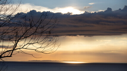 Fototapeta premium bed of clouds covering sun during sunset