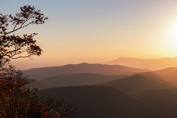 A soft orange, yellow, sunset over the layers of the Appalachian Mountain range from Shenandoah National Park, Virginia, USA.
