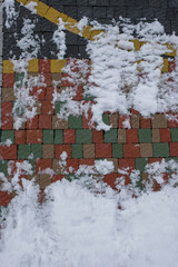 The pavement of pale colors. Samples. Snow on the pavement. Vertical image. 
