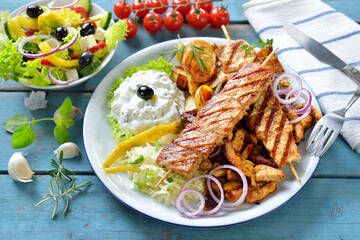 Griechischer Grillteller mit Tzatziki und Krautsalat, dazu ein kleiner Bauernsalat mit Feta – Greek mixed grill with gyros, souflaki,  tzatziki and coleslaw, served with a farmers salad