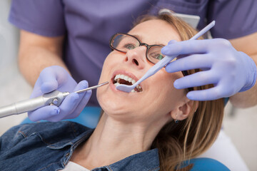 Close up of a mature woman having her teeth examined by dentist
